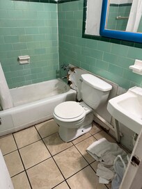 Huge hole in wall by bathtub