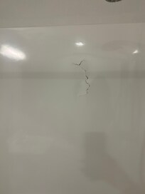 Hole and crack in the shower wall