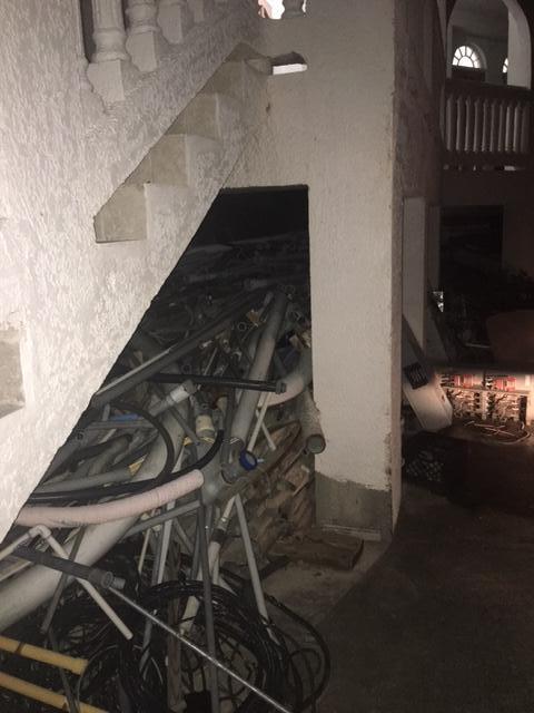 Debris under stairs leading to the unit