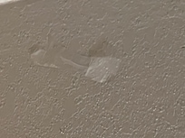 Tape on wall over head of bed