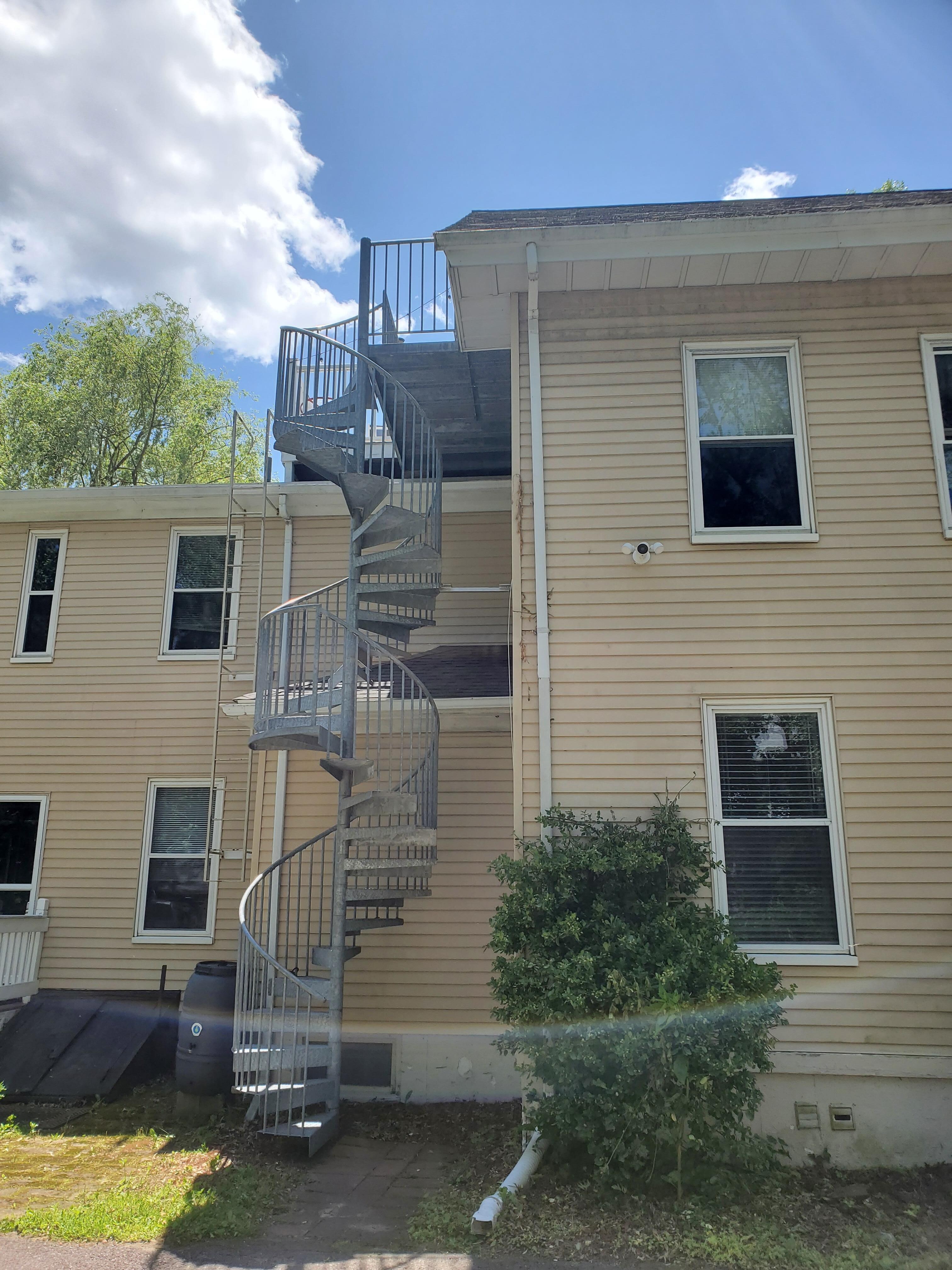 Outside spiral staircase access to 3rd fl apt and deck