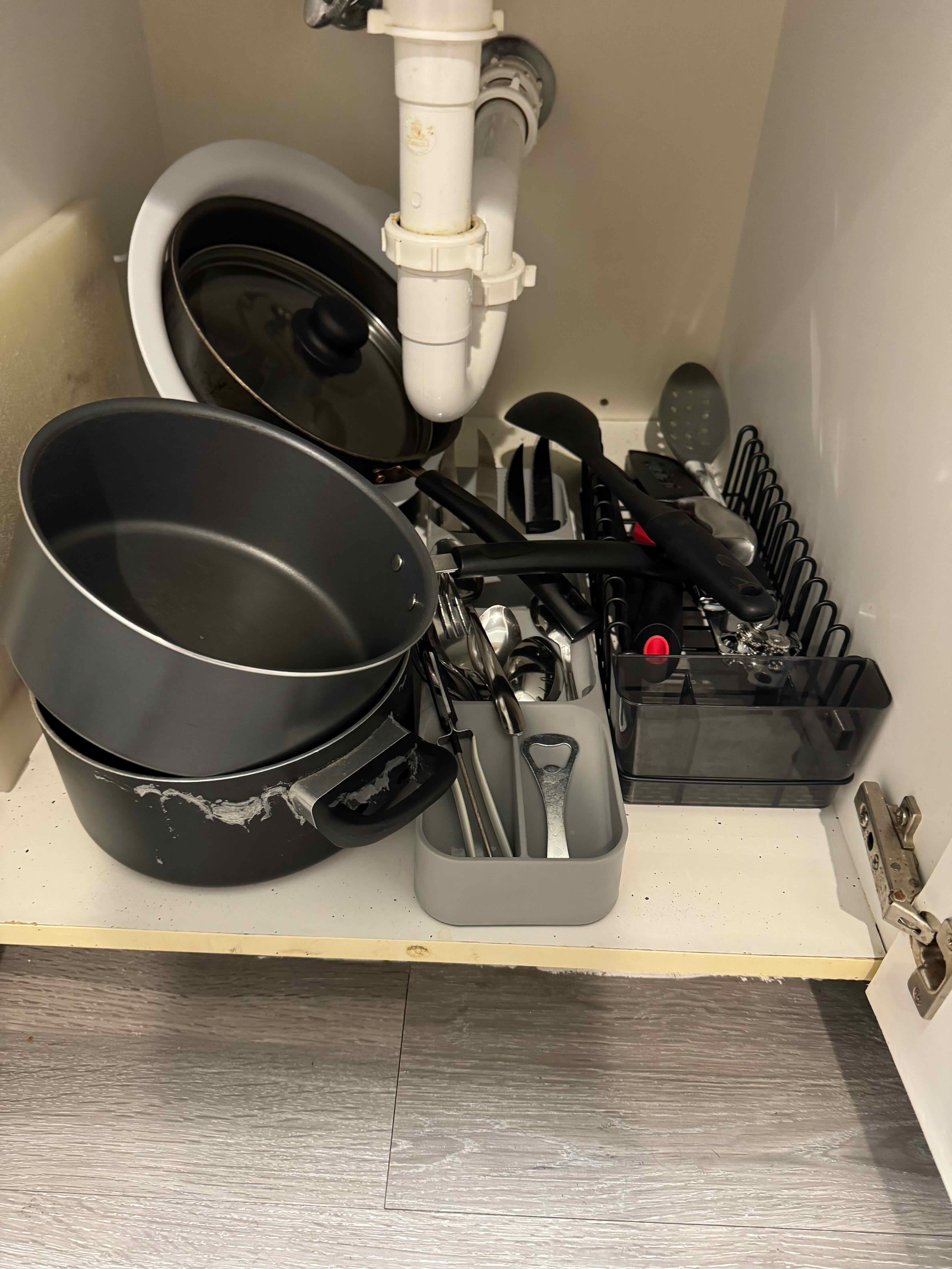 The pots, pans, utensils etc were dumped under the sink.  They were not clean.  Nor were the plates.  