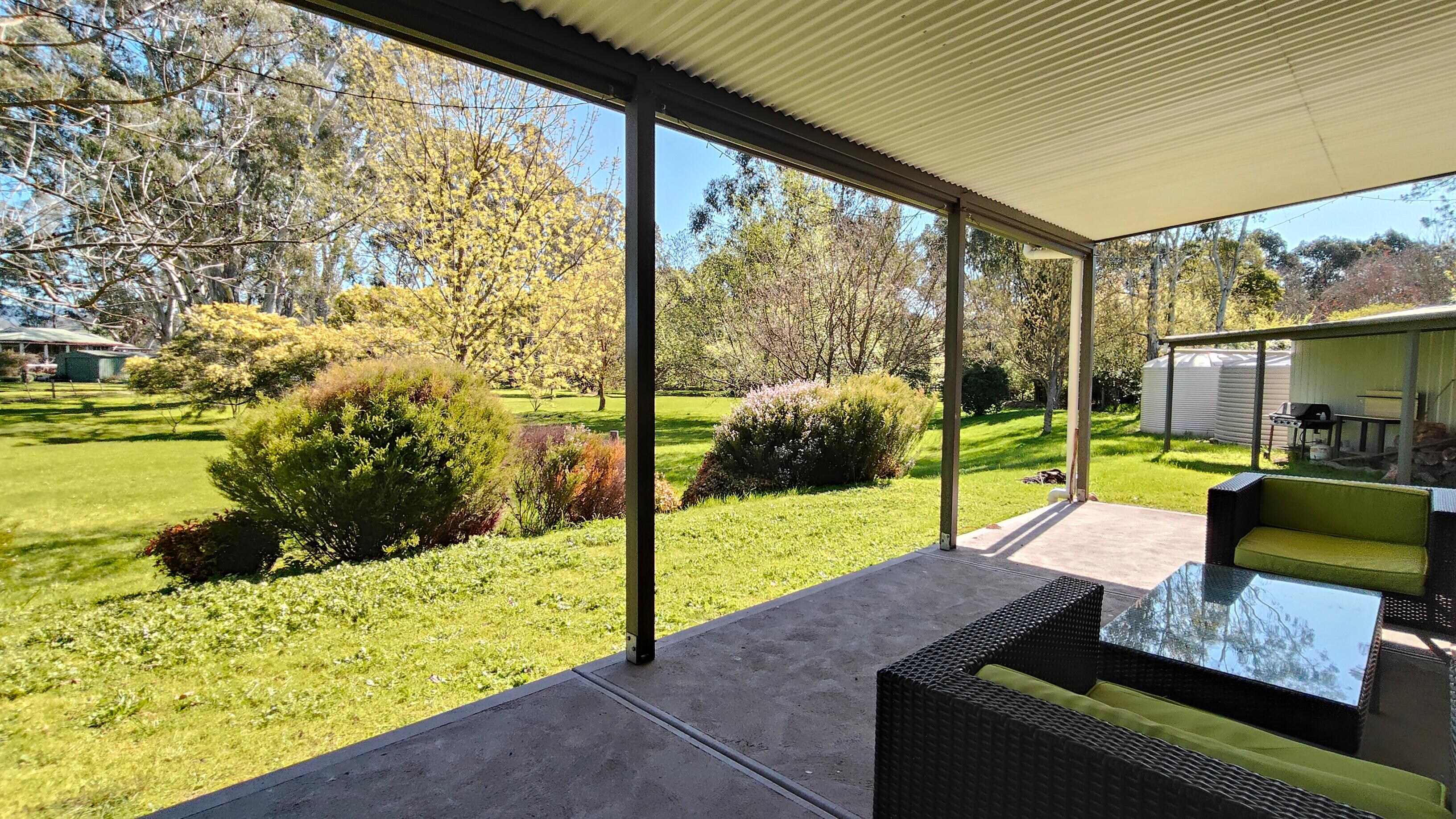 The outdoor lounge has a lovely view of the large backyard with its secretive frog pond right at the back of the property.