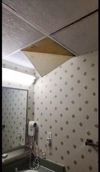 Ceiling tile peeling in the bathroom