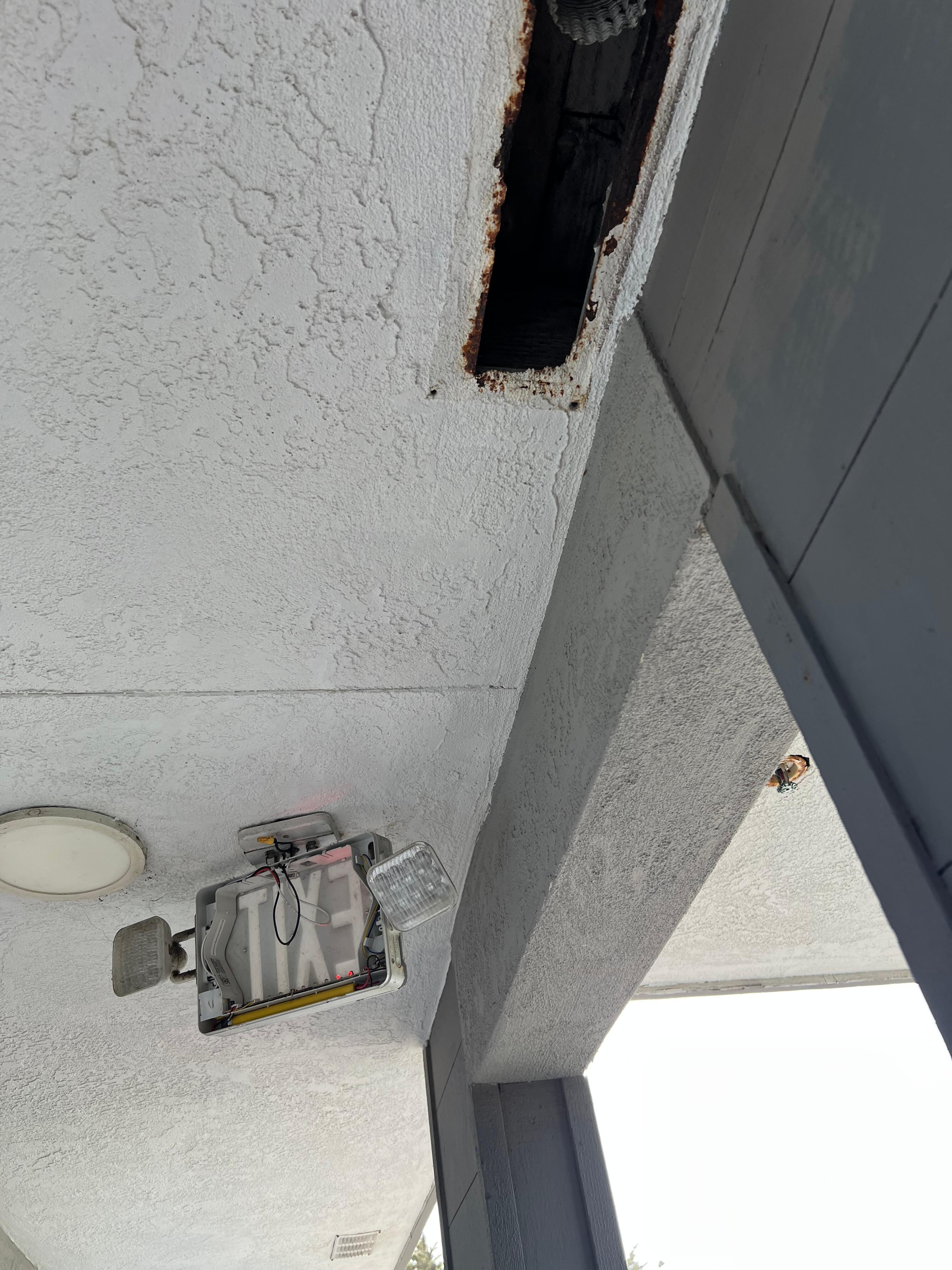 Broken exit signs and no cover on the vent. 