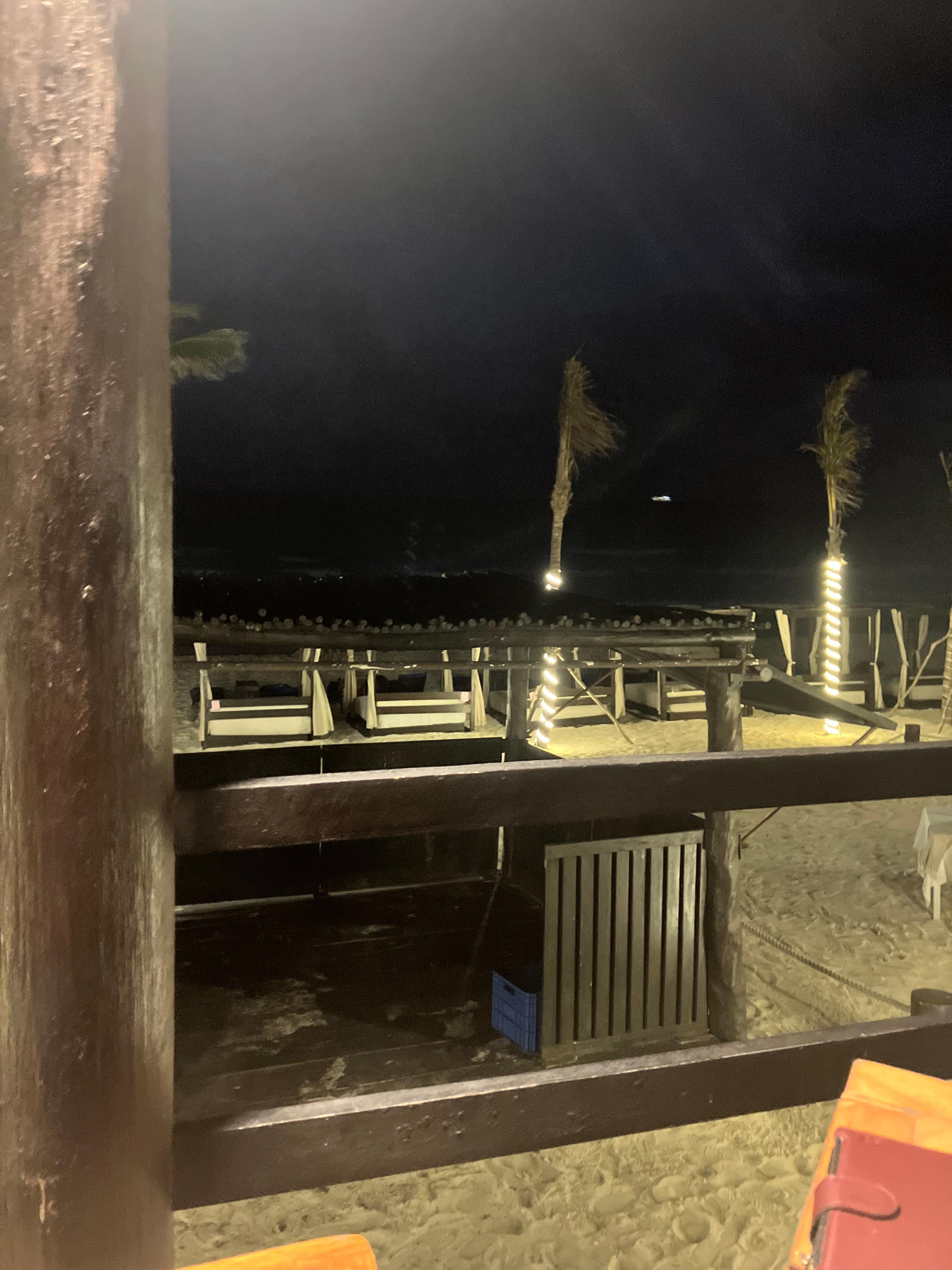 Night view near the hotel entrance from the beach side and pool 