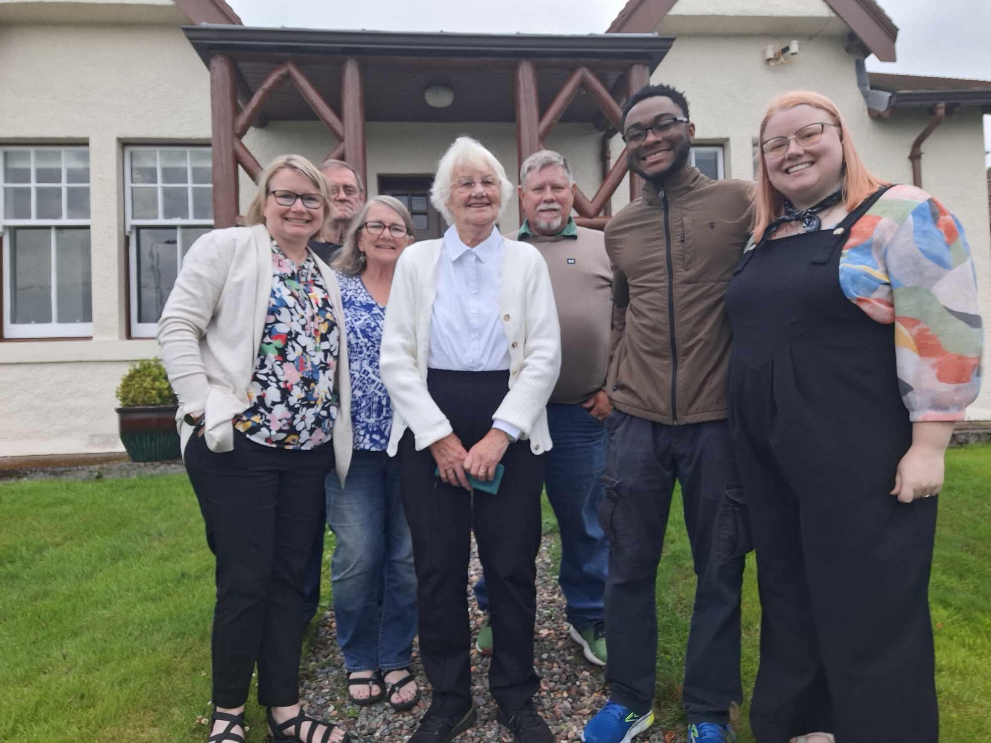 Family in front of cottage