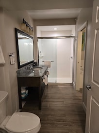 Bathroom, large stand up shower,sink with vanity top. Washer and dryer located in here in a closet.