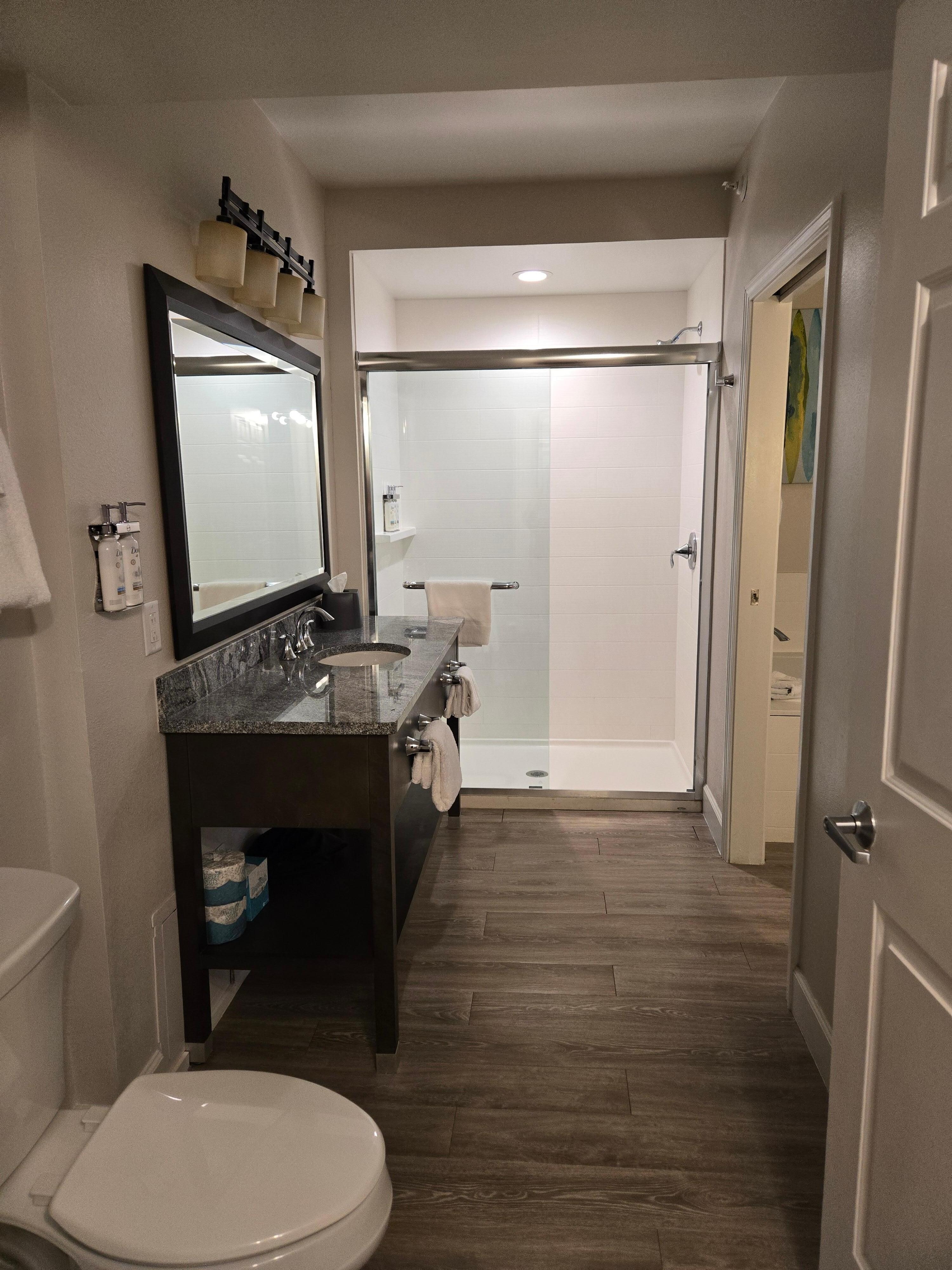 Bathroom, large stand up shower,sink with vanity top. Washer and dryer located in here in a closet.