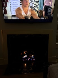 Beautiful gas fireplace and large smart TV.