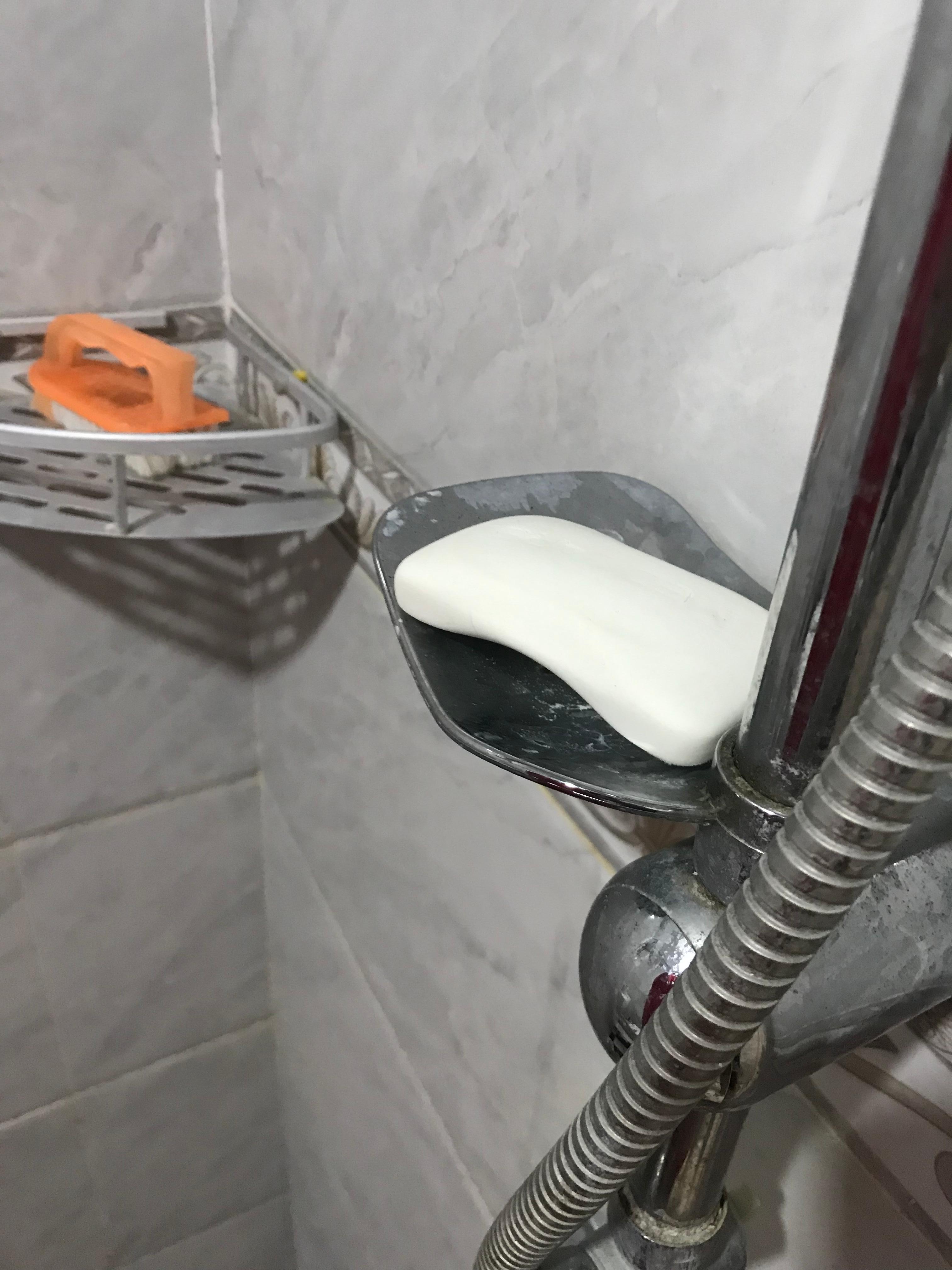 Dirty shower with someone’s old used soap.