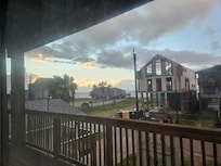 View from front balcony towards the left side looking at beach. Construction home in front of our rental