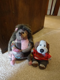 This is our little Baxter hanging out with the door stop his new friend Hedgie the Hedgehog.