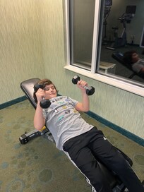 The boy working out in the fitness center.