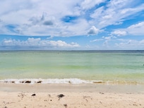 Calm, clear bay beach steps away.