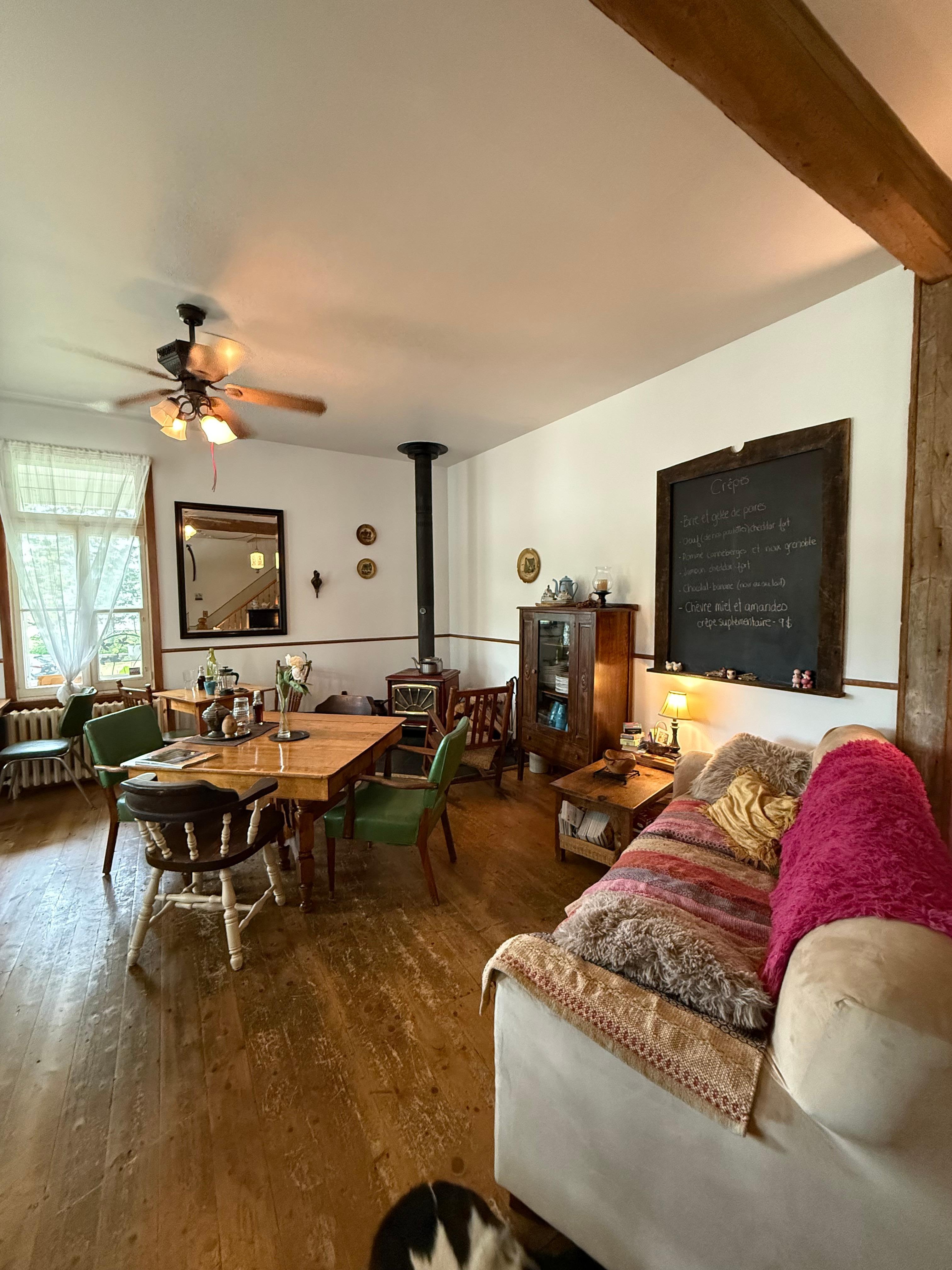 Lovely guest dining room, with individual tables and lots of unique antiques