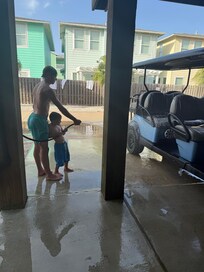 Washing the sand off the golf cart