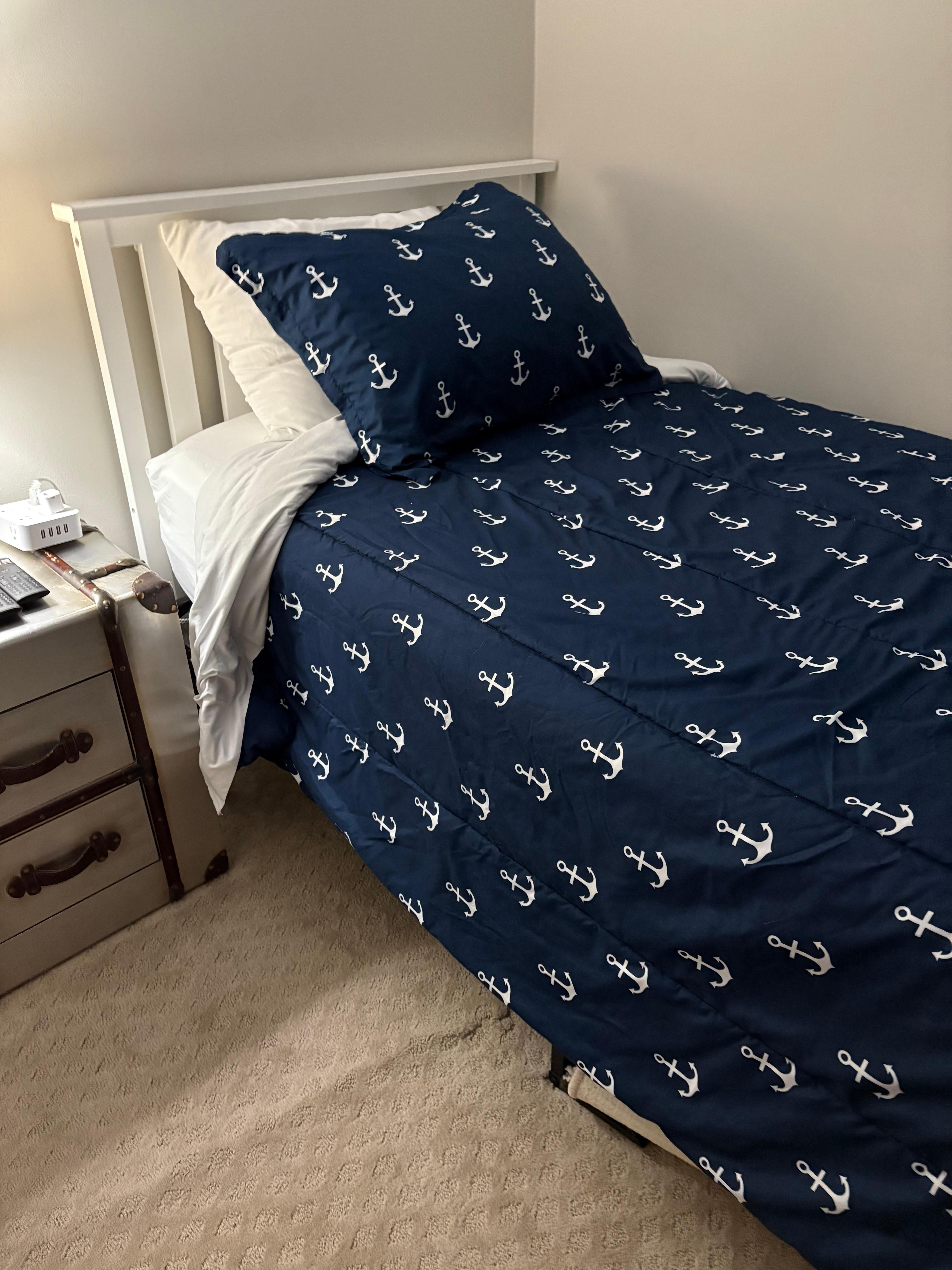 One of two twin beds in 3rd bedroom. Room under beds for suitcase storage.