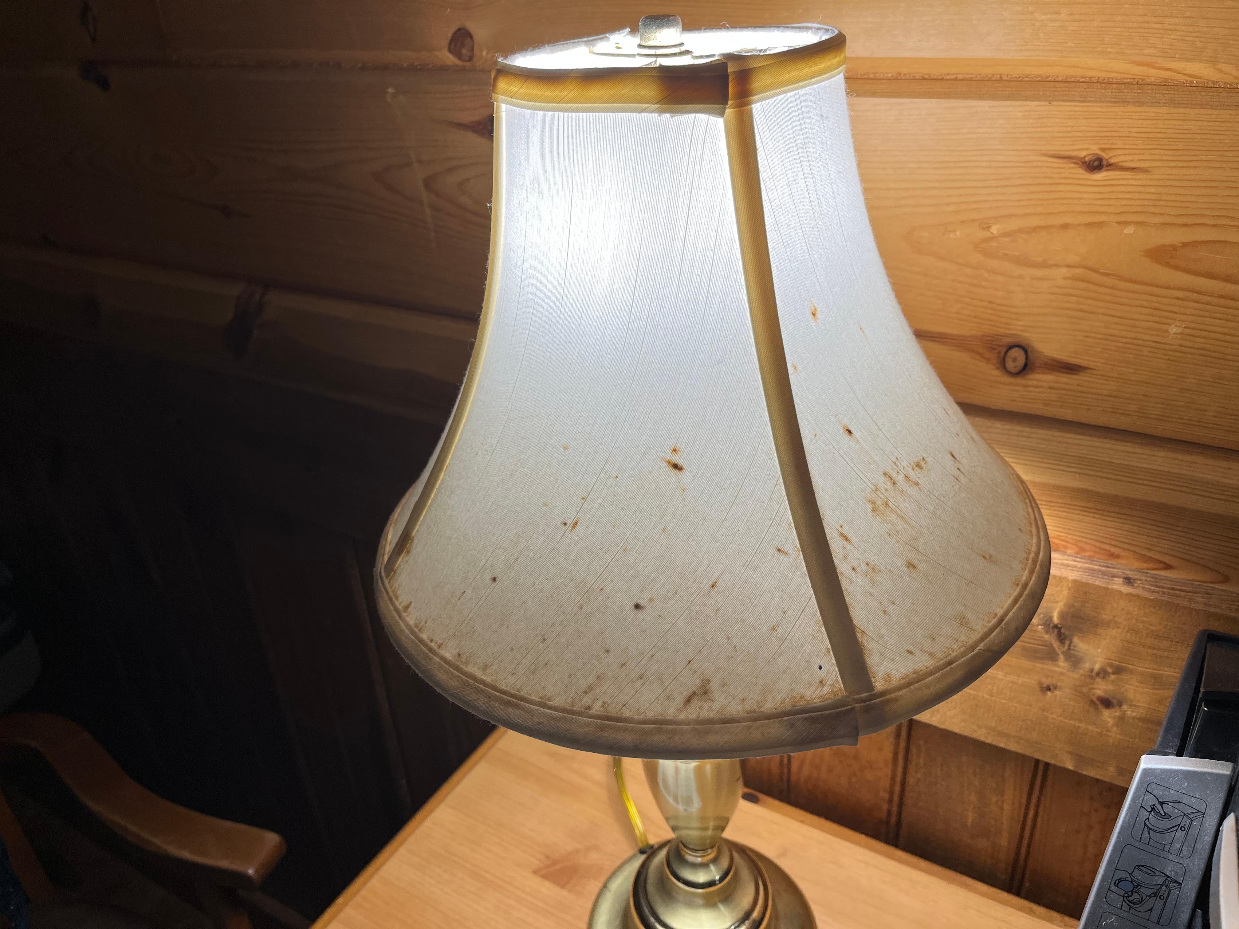 This was the condition of the lampshade on the lamp that had to be  plugged in/out to use.