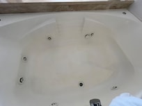 Hot tub has green rust indicates that metal particles (like copper) are oxidizing in the water.