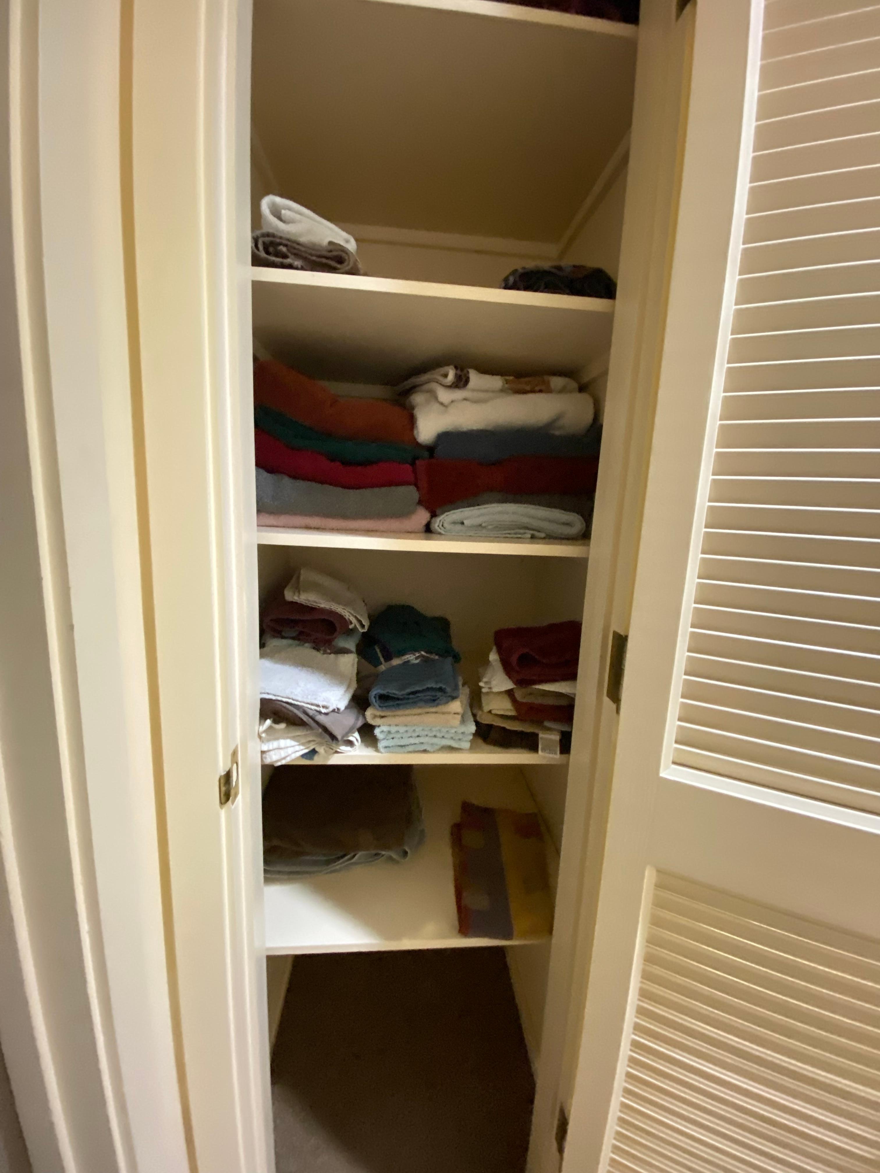 Hallway linen closet with towels. 