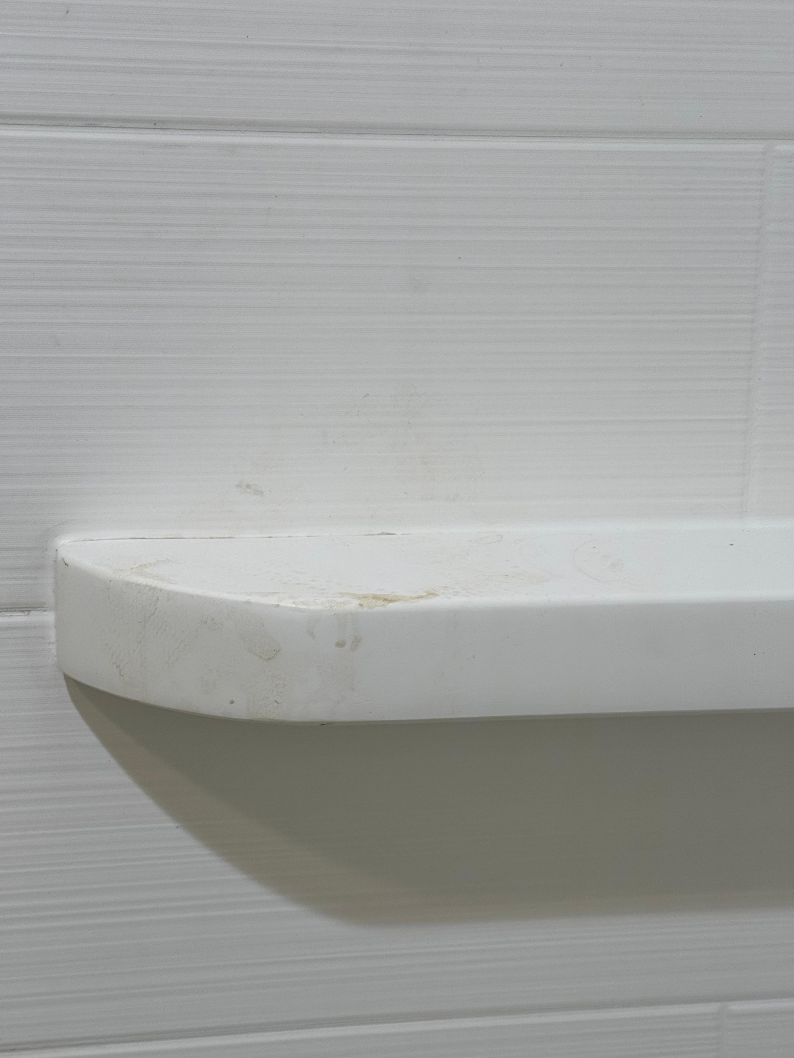 Unclean shelf in shower 