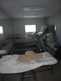 Fitness room. Sign that said out of order but this was all in it. Looks like it was used for storage or house someone but the look of the beda