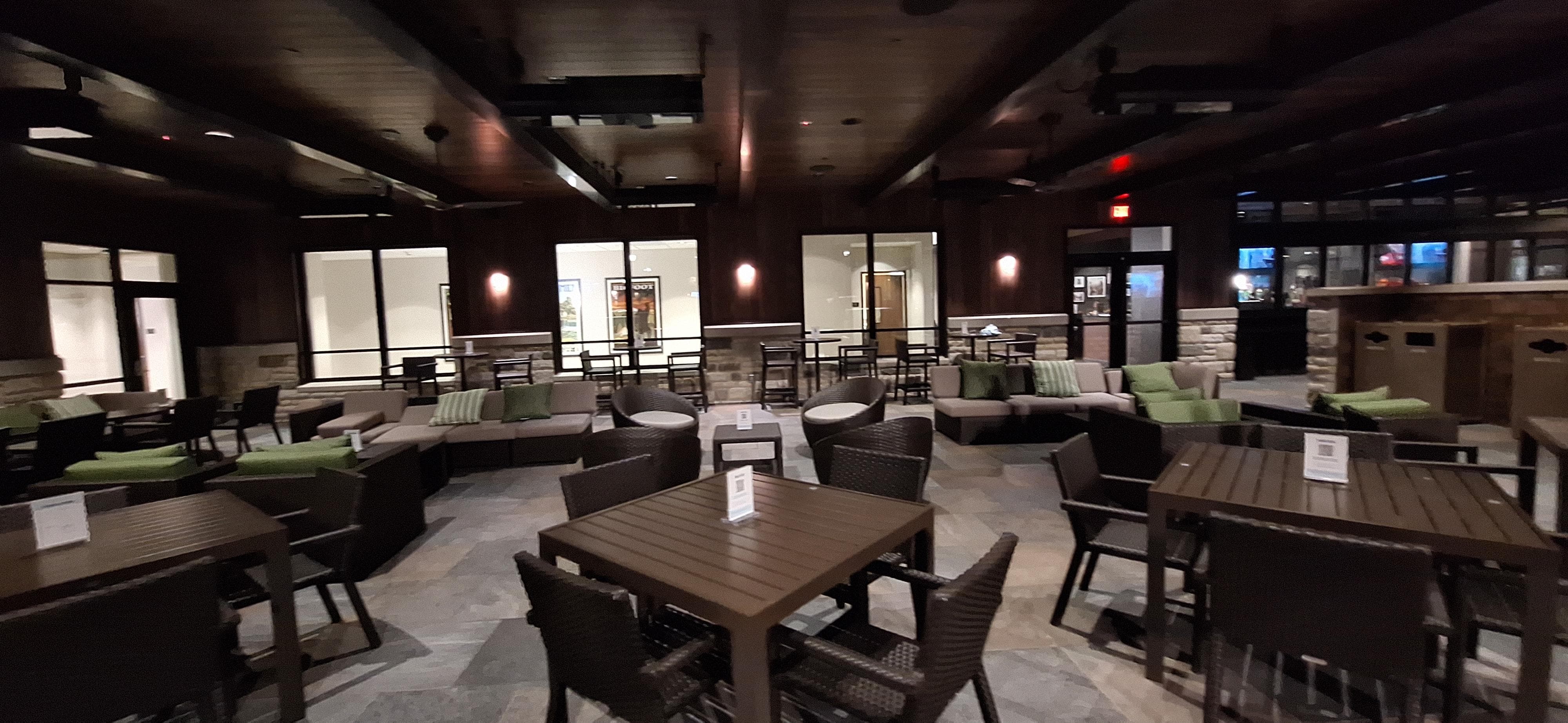 Covered outdoor patio with ceiling heaters/fans and large mounted TVs