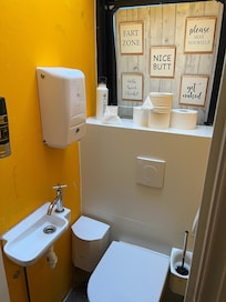 A shower which is a toilet and sink