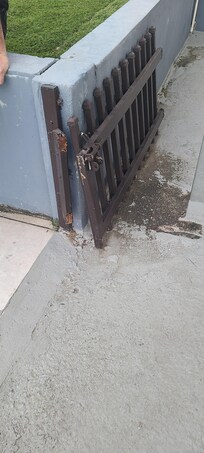 Broken and rusty gate by pool
