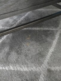 Dried vomit from previous guest clearly visible under coffee table