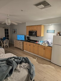 Full kitchen. Pots, pans, cups, plates, silverware.