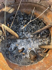 Cigarette butts in fire pit outside