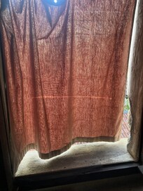 Moustiquaire de la chambre, non fixée au cadre de la fenêtre et trouée