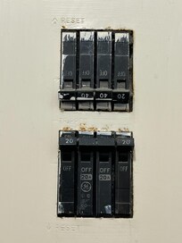 Thereās not a zoomed out photo but this exposed and uncovered electrical panel is 8 inches away from the shower!
