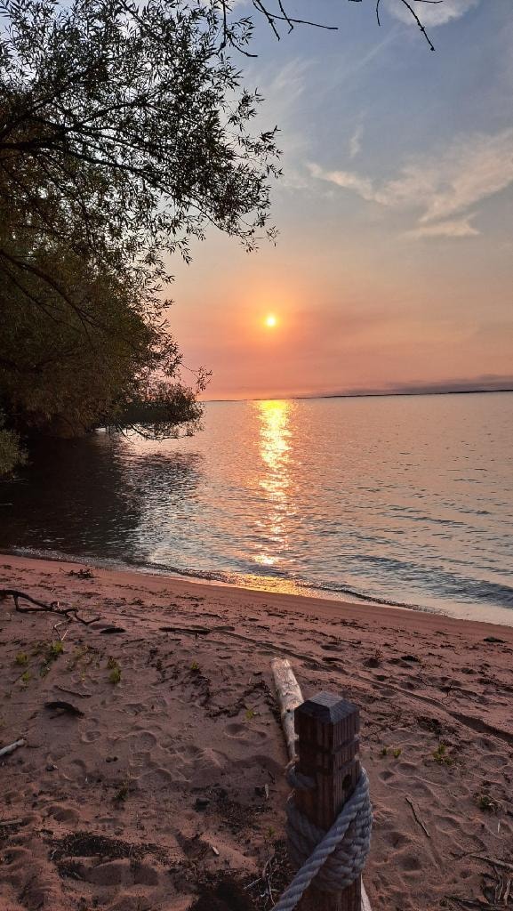 looking over the beach into the lake at the house