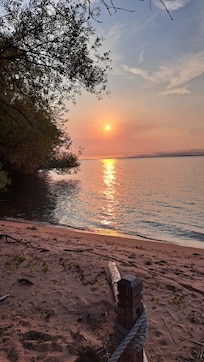 looking over the beach into the lake at the house