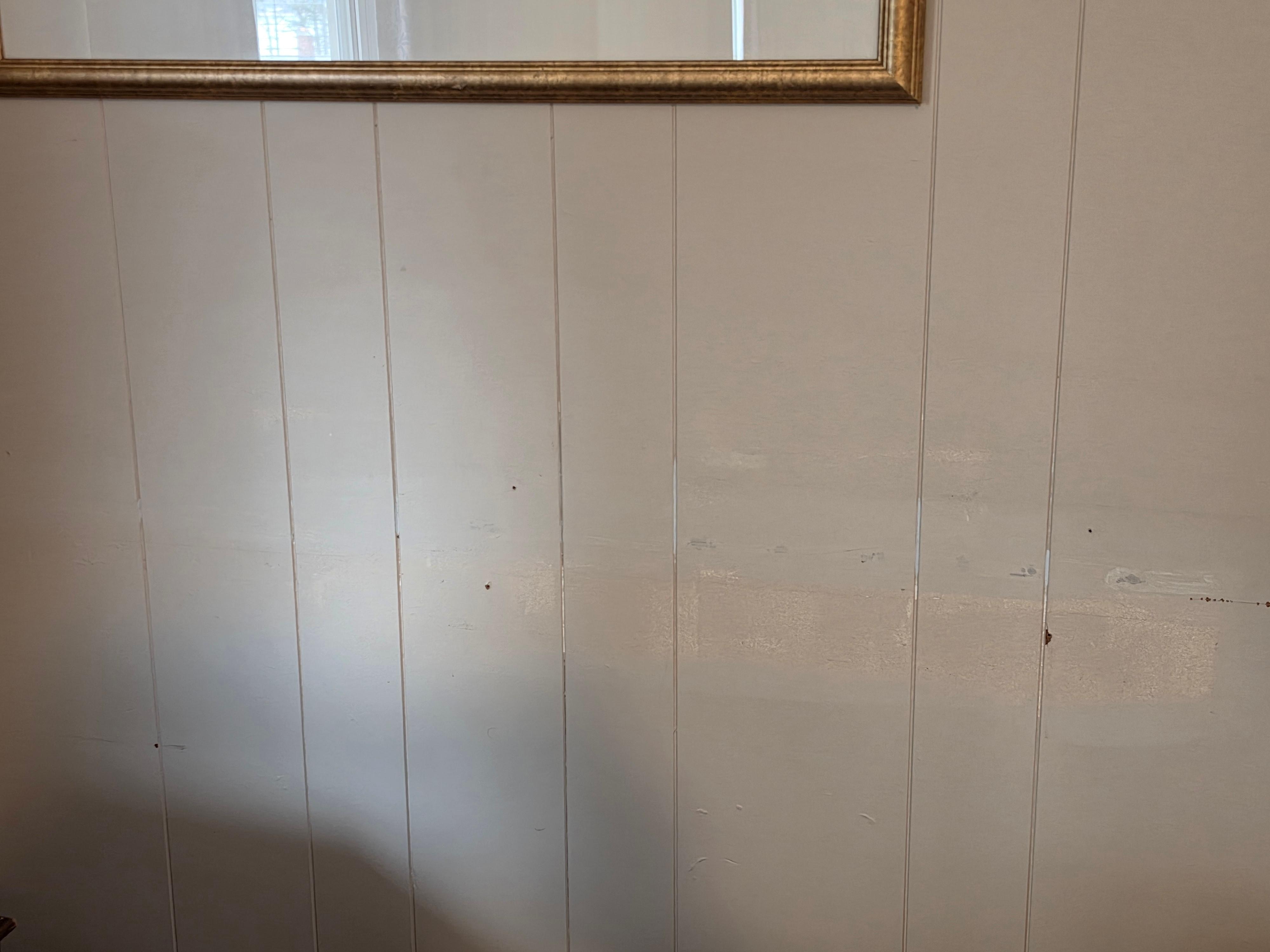 Scratches on wall and mismatched paint.