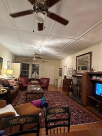 Living room with comfortable sitting chairs and sofa. Dining table (not fully pictured) has 6 chairs- as well as table and 4 chairs in kitchen.