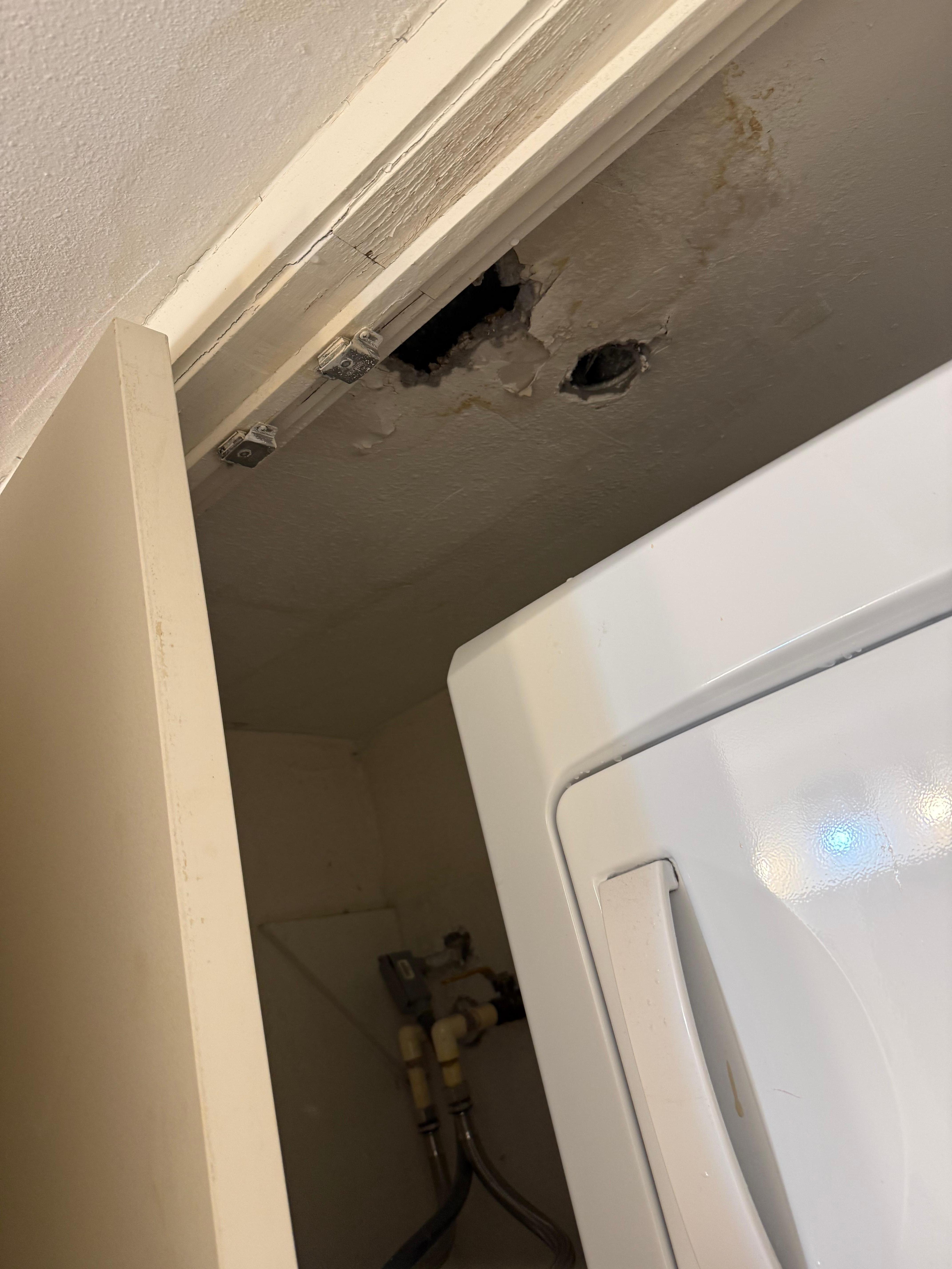 hole above washer/dryer in b/r 