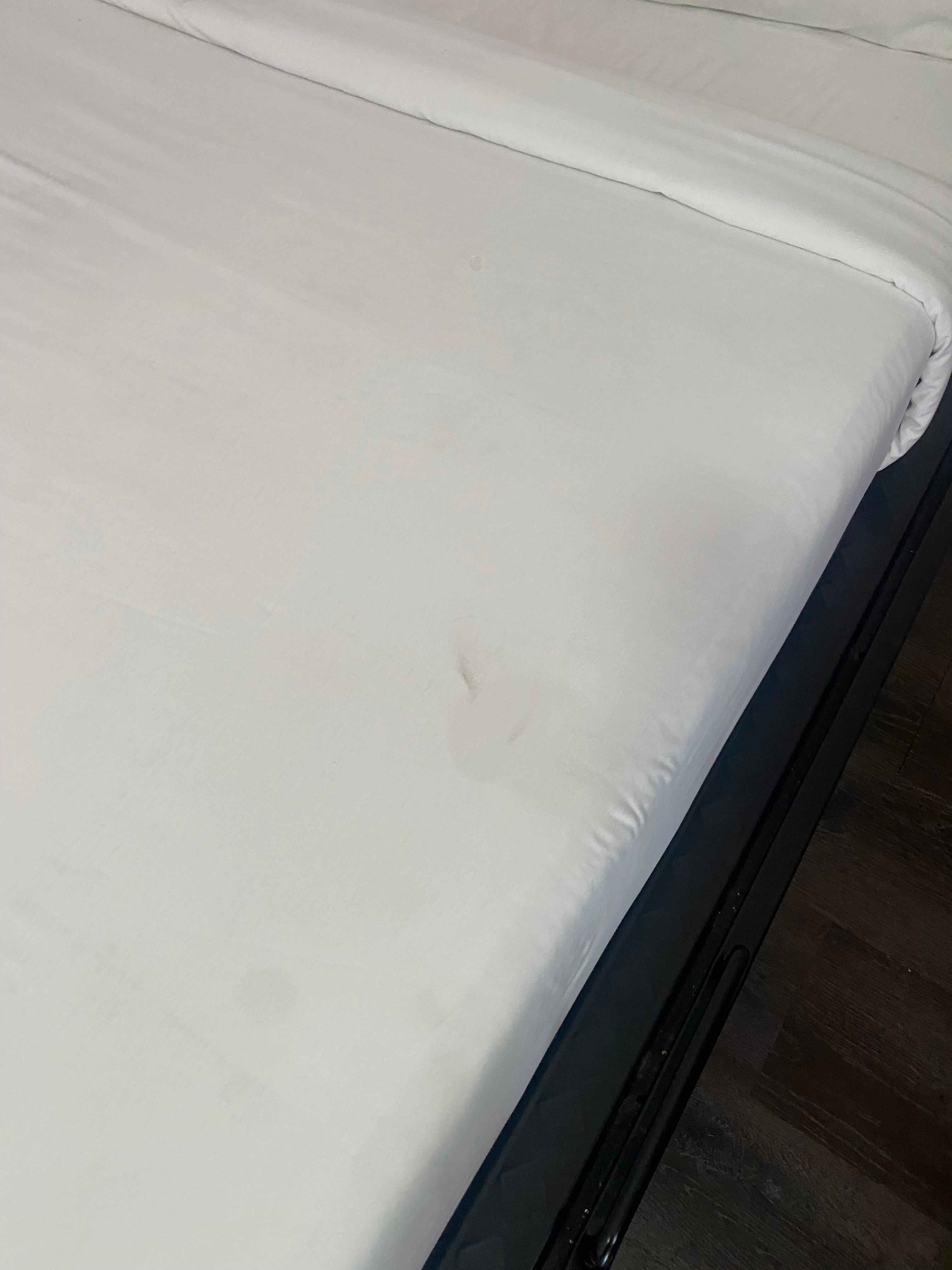 Dirty bed sheets, mattress smaller than frame