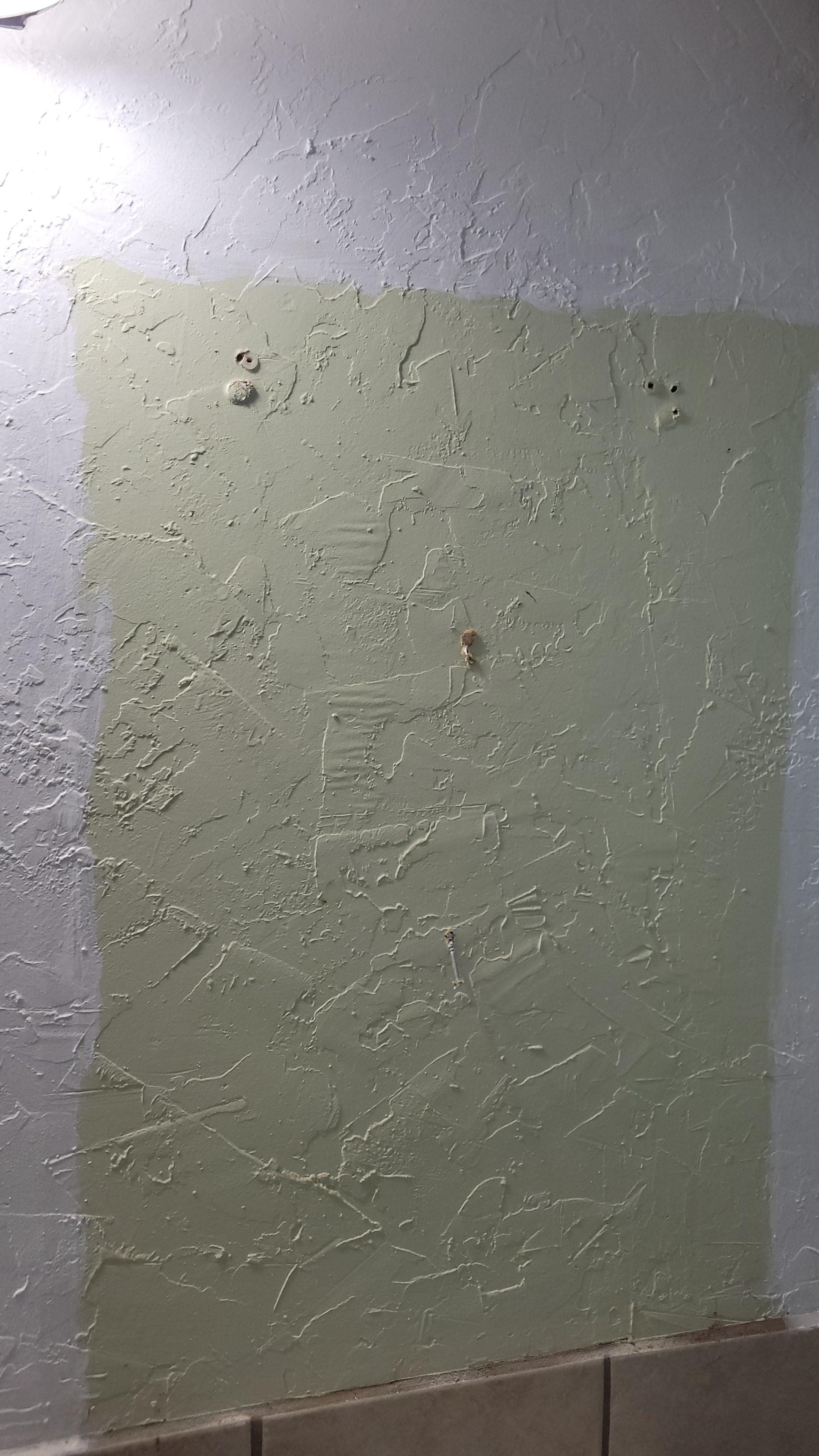 Holes on the wall from where the cabinet fell