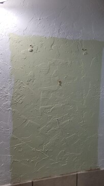 Holes on the wall from where the cabinet fell