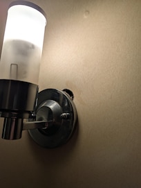 Hole near light sconces.