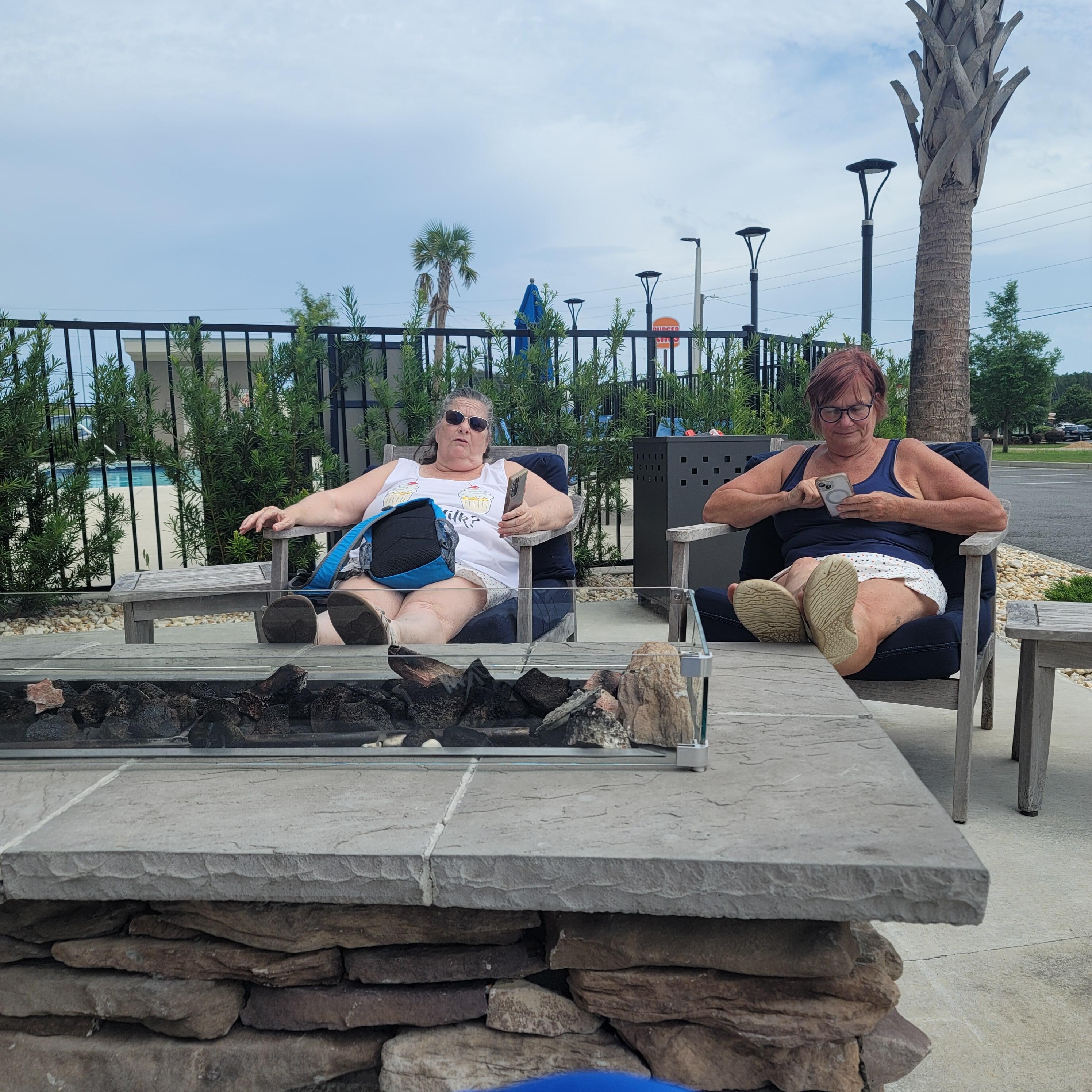 Fire pit seating area out by the pool.
