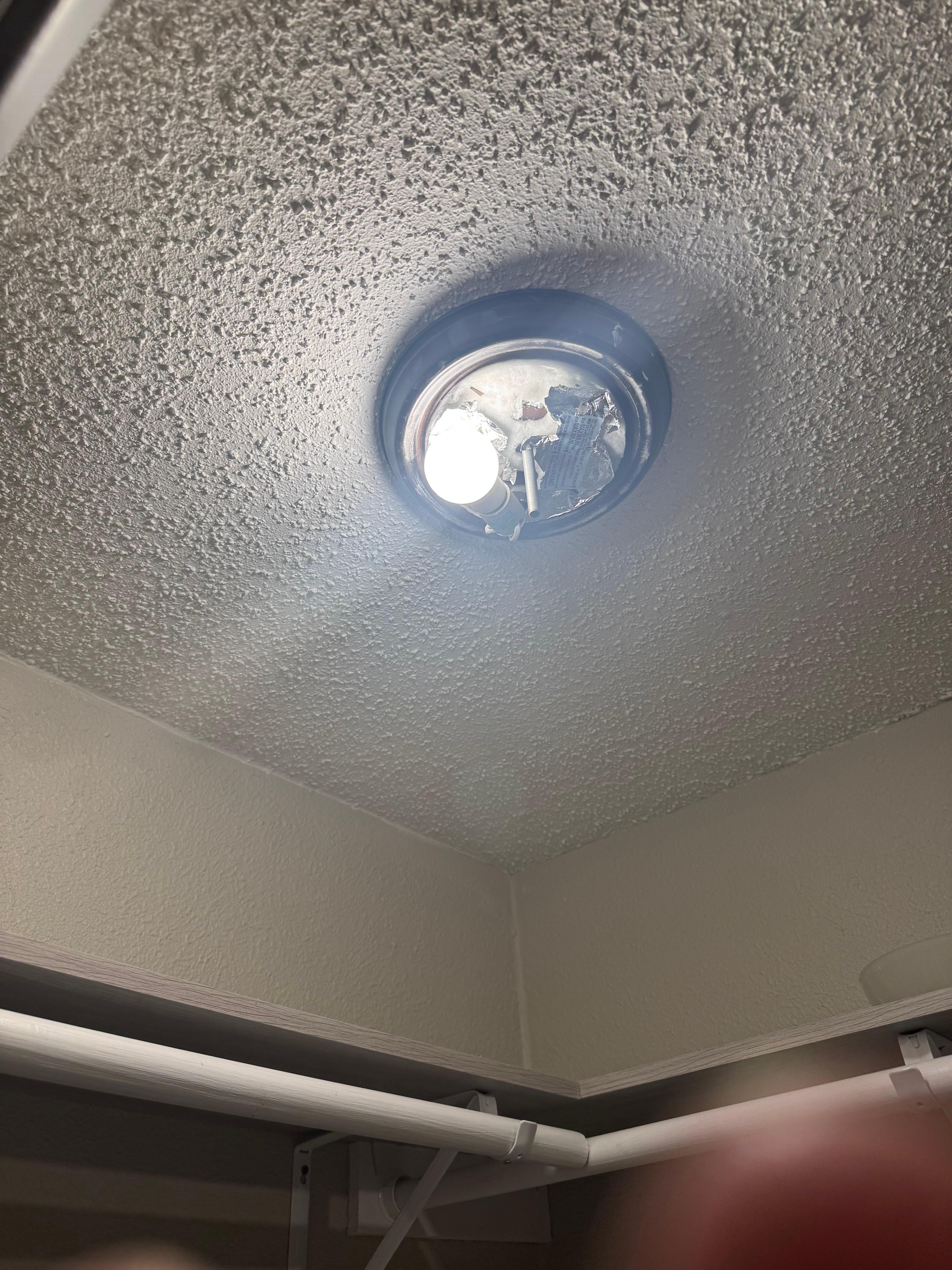 Missing light cover and burnt out bulb. 