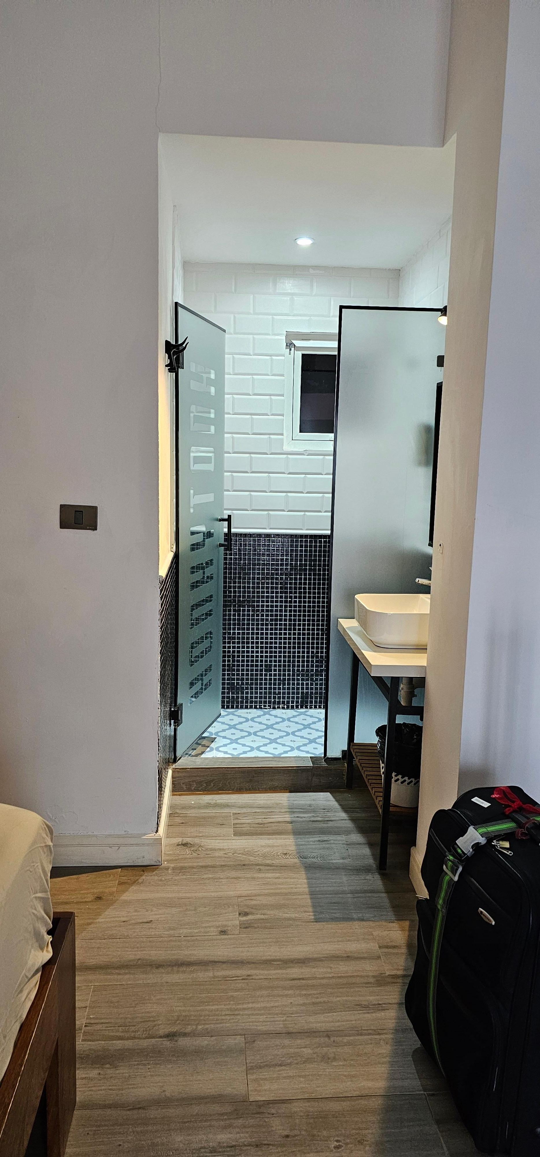 Bathroom and Sink. Toilet is in a small room by itself.