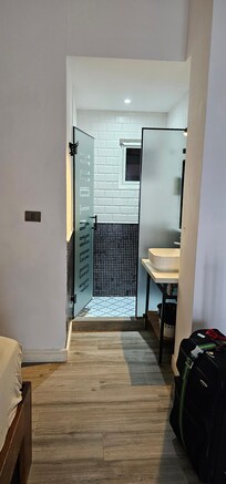 Bathroom and Sink. Toilet is in a small room by itself.