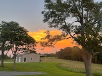 View of shed from house at sunset