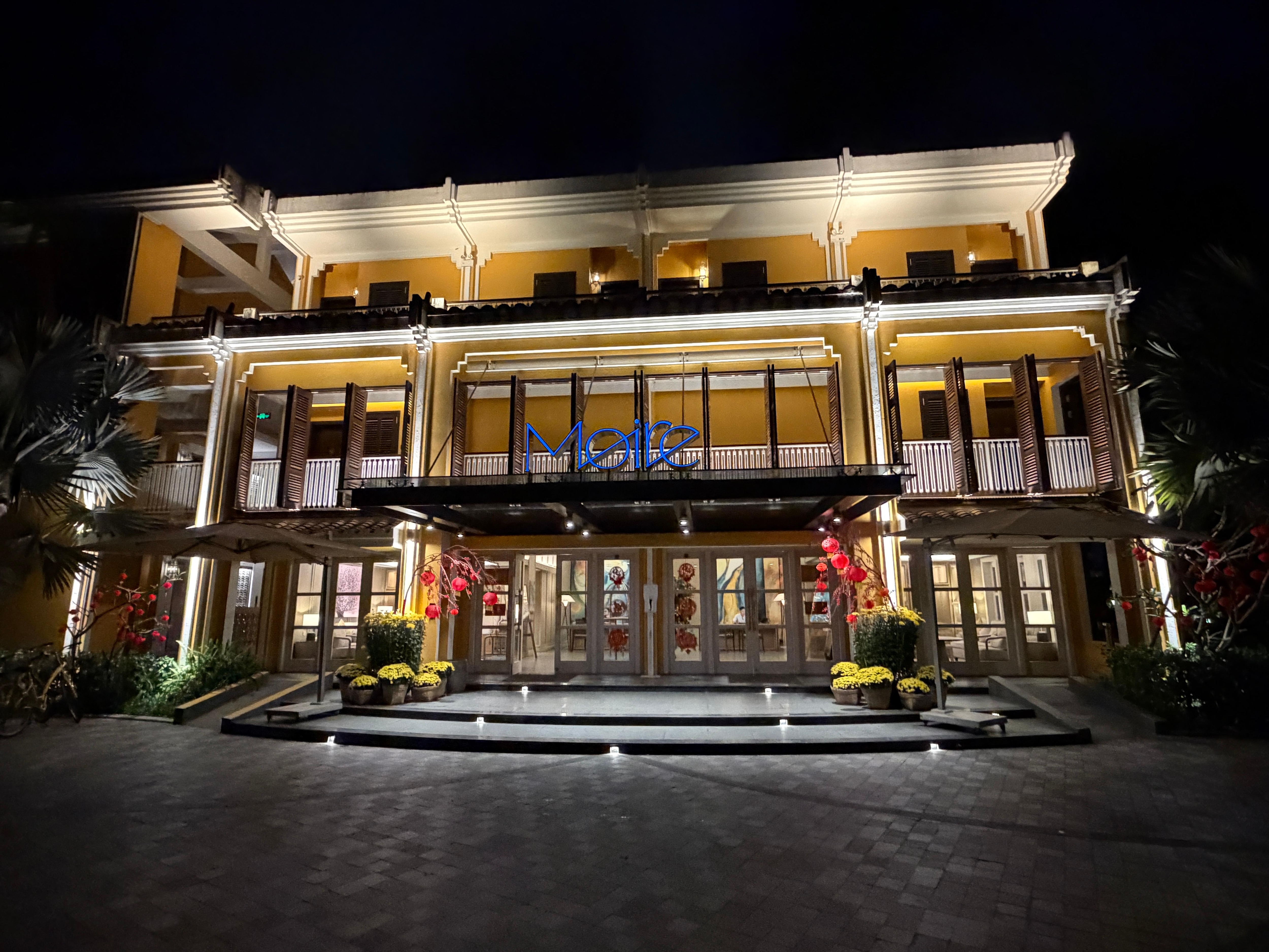 Front of hotel at night.